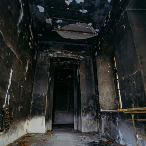 burnt interior after fire. Walls in black soot. need fire damage restoration